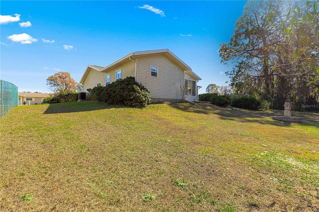 view of home's exterior with a lawn