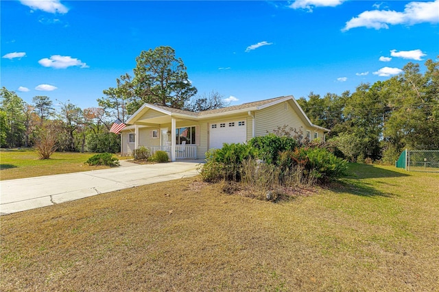 view of front of home with a garage, a front yard, and covered porch