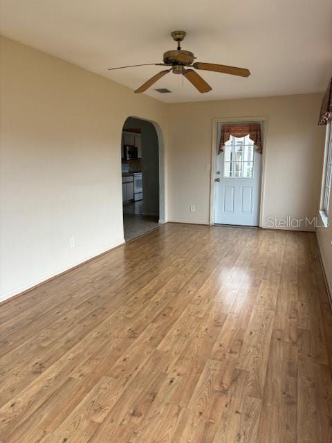 empty room featuring ceiling fan and light hardwood / wood-style flooring