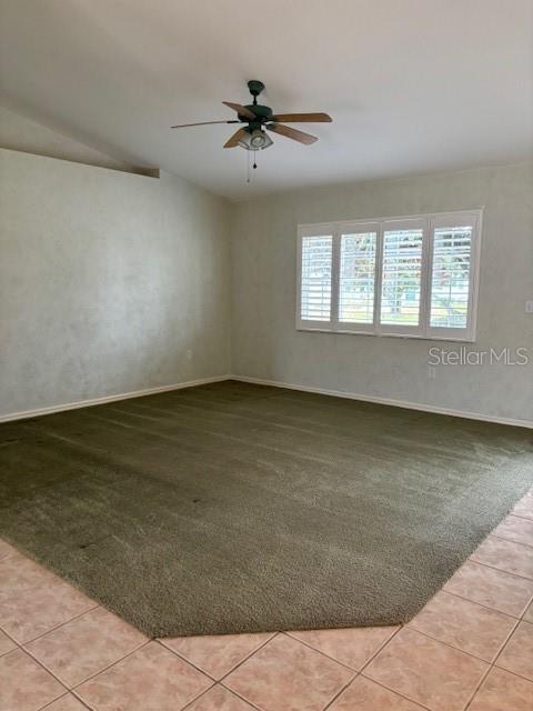 spare room featuring light tile patterned flooring and ceiling fan