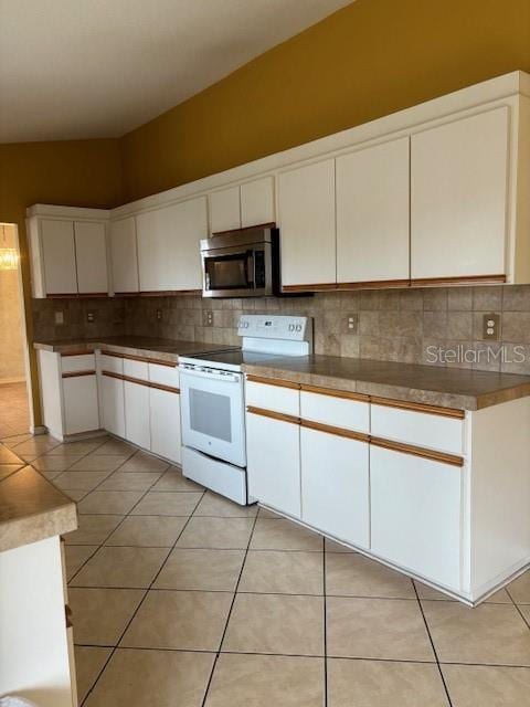 kitchen featuring light tile patterned floors, backsplash, white electric stove, and white cabinets