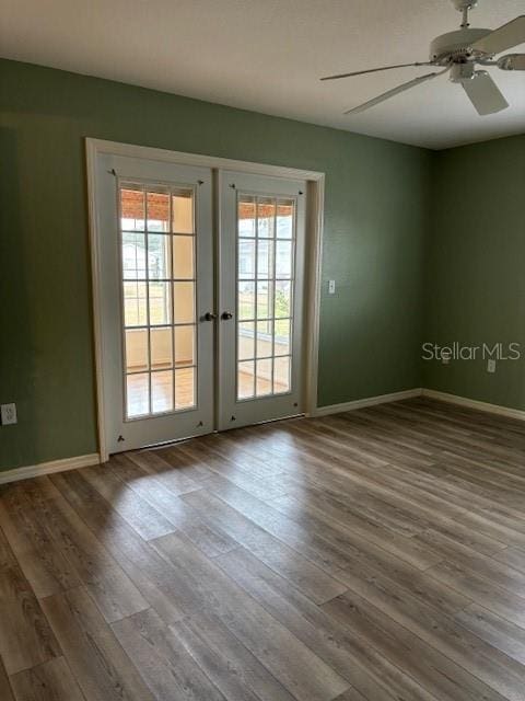 spare room with french doors, ceiling fan, and wood-type flooring