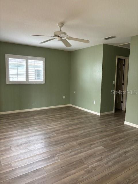 spare room with hardwood / wood-style flooring and ceiling fan