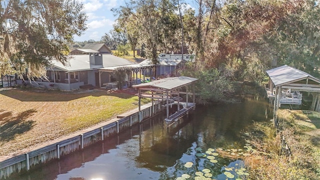 dock area with a yard and a water view