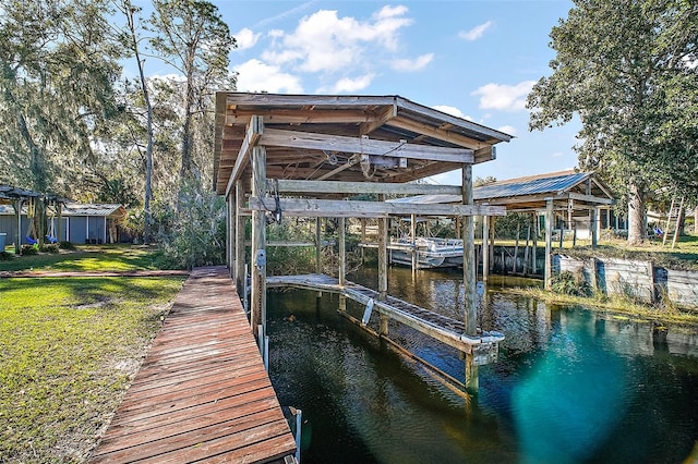 view of dock featuring a water view and a yard