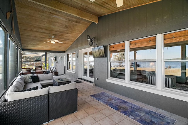 sunroom with ceiling fan, vaulted ceiling with beams, and wooden ceiling