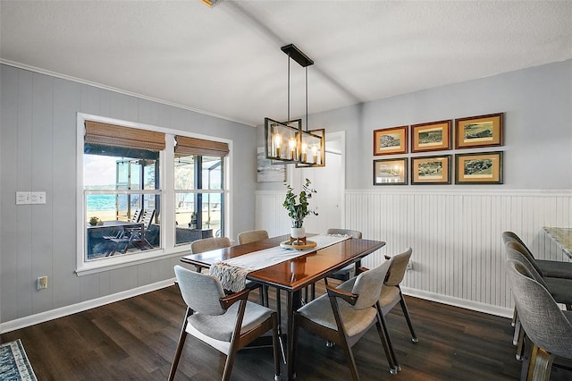 dining room with dark hardwood / wood-style flooring and an inviting chandelier