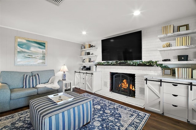 living room with dark hardwood / wood-style flooring, a fireplace, and ornamental molding