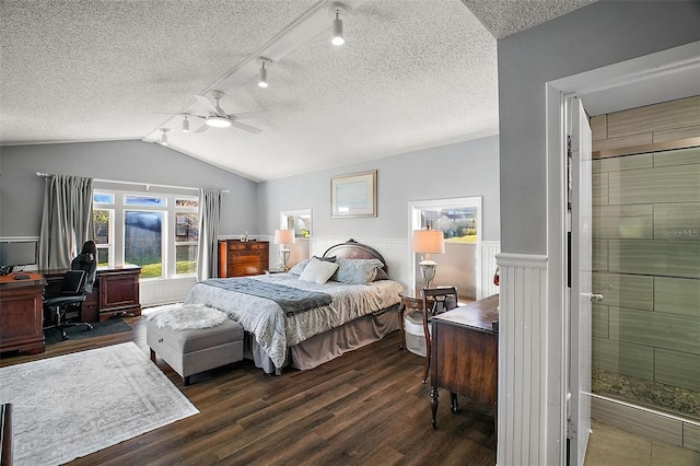 bedroom with a baseboard radiator, a textured ceiling, dark hardwood / wood-style flooring, vaulted ceiling, and ceiling fan