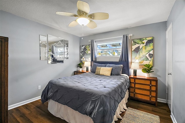 bedroom with ceiling fan, a textured ceiling, and dark hardwood / wood-style flooring