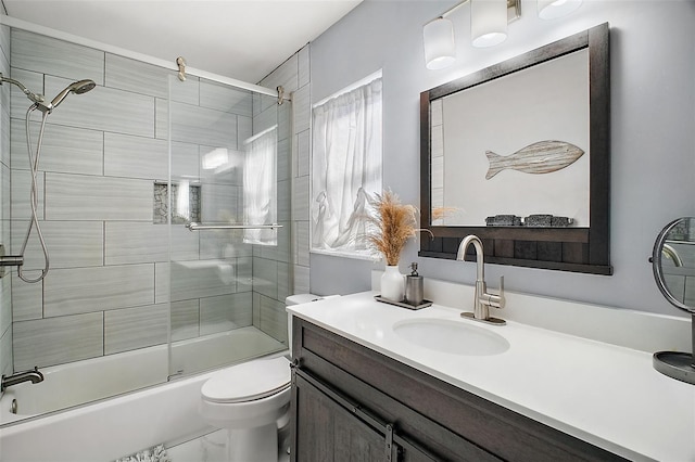 full bathroom featuring bath / shower combo with glass door, toilet, and vanity