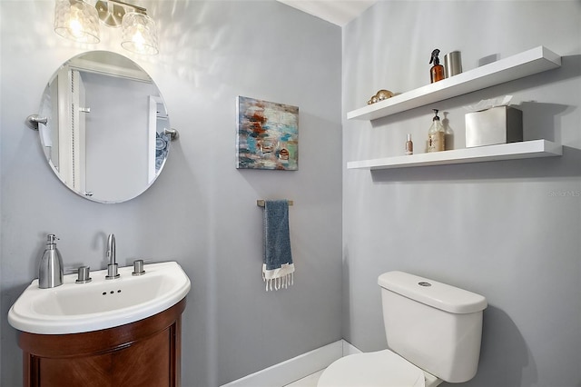 bathroom featuring toilet and vanity