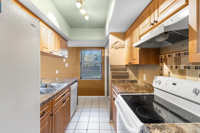 kitchen featuring light tile patterned floors, sink, and white appliances