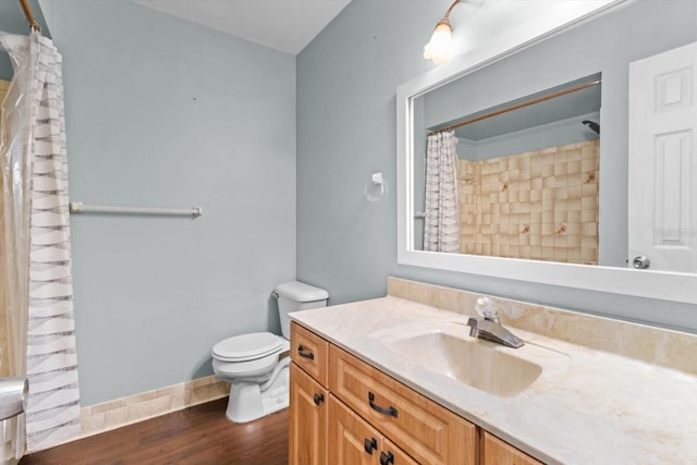 bathroom featuring toilet, hardwood / wood-style floors, and vanity