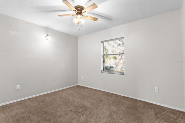 empty room with ceiling fan and carpet flooring