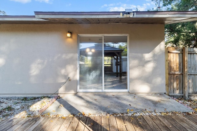 view of exterior entry featuring a deck