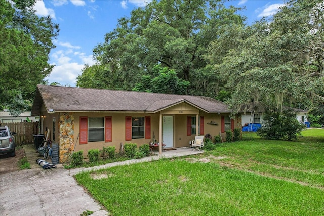 ranch-style home with a front yard and a porch