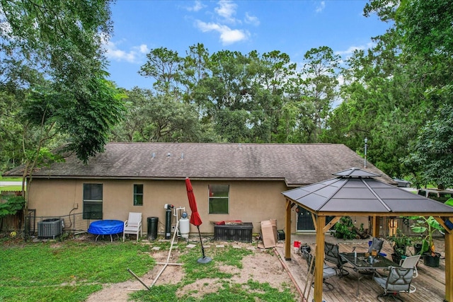 rear view of house featuring a deck, a gazebo, and cooling unit