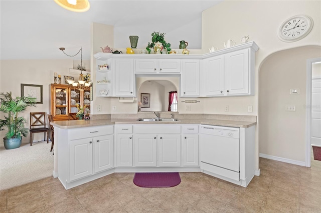 kitchen featuring dishwasher, sink, white cabinets, and kitchen peninsula