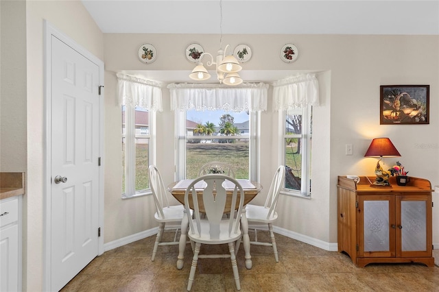 dining space with an inviting chandelier