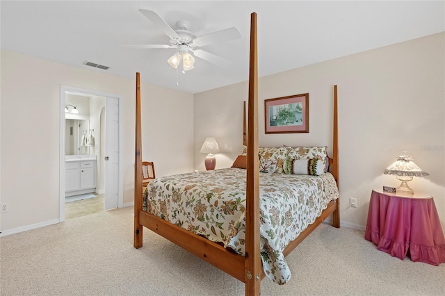 carpeted bedroom with connected bathroom and ceiling fan