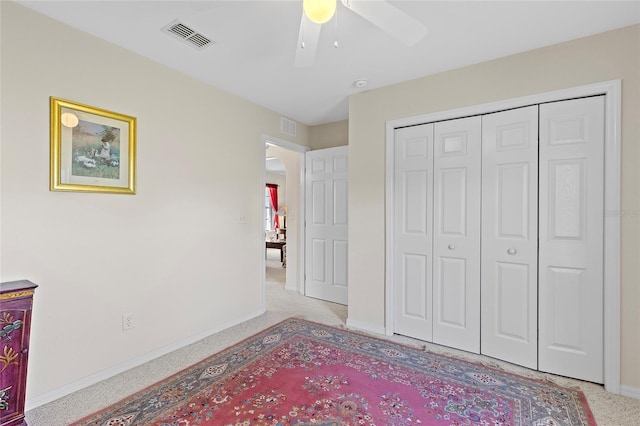 carpeted bedroom with a closet and ceiling fan