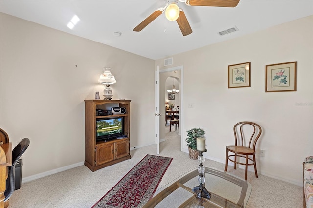 sitting room with ceiling fan and light carpet