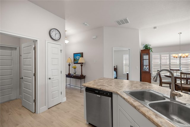 kitchen with white cabinets, decorative light fixtures, sink, light wood-type flooring, and stainless steel dishwasher