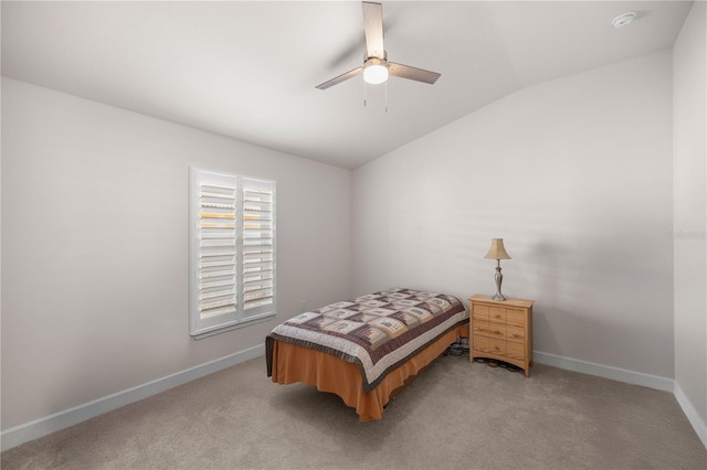 carpeted bedroom with ceiling fan and vaulted ceiling