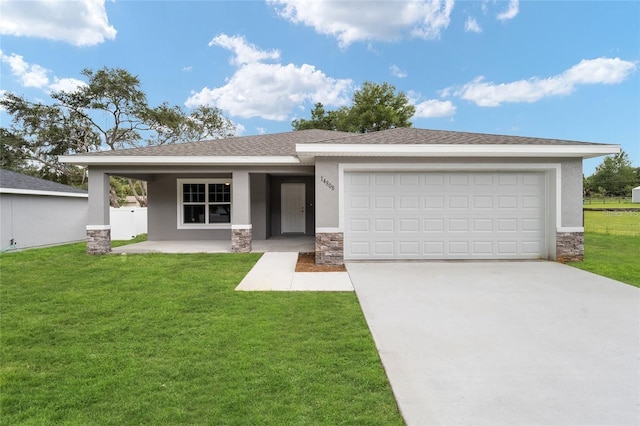 view of front facade featuring a garage and a front lawn