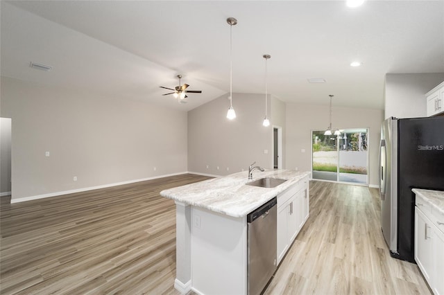 kitchen featuring white cabinetry, stainless steel appliances, an island with sink, sink, and vaulted ceiling