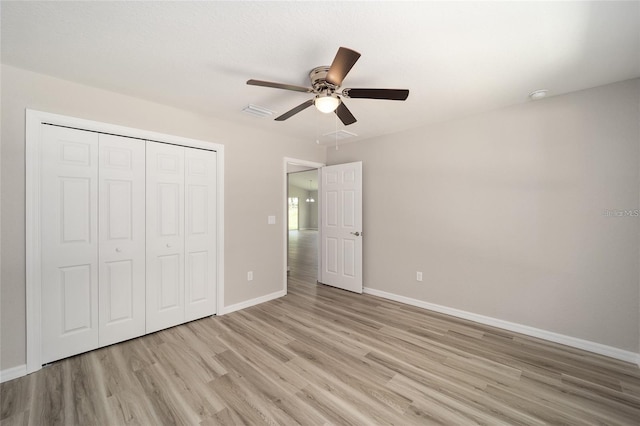 unfurnished bedroom featuring a closet, ceiling fan, and light hardwood / wood-style flooring