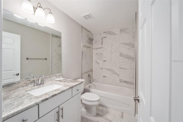 full bathroom with a textured ceiling, toilet, vanity, and tiled shower / bath