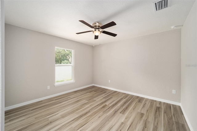 unfurnished room with ceiling fan, a textured ceiling, and light hardwood / wood-style flooring