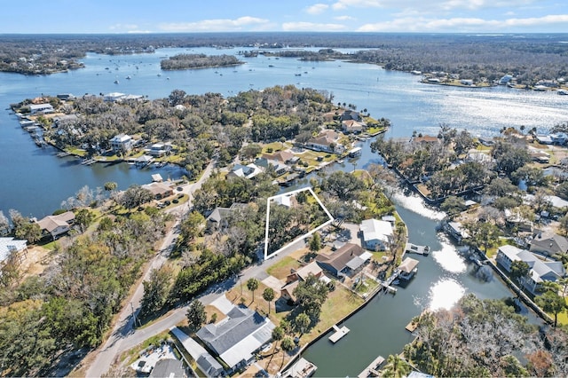 birds eye view of property with a water view and a residential view