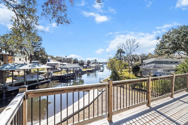 wooden deck with a water view and a boat dock