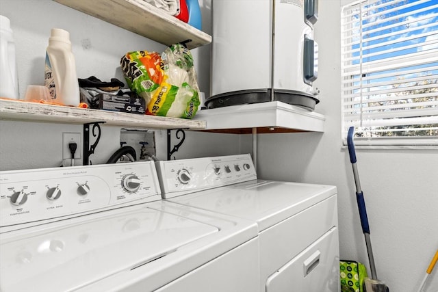 clothes washing area featuring washing machine and dryer and laundry area