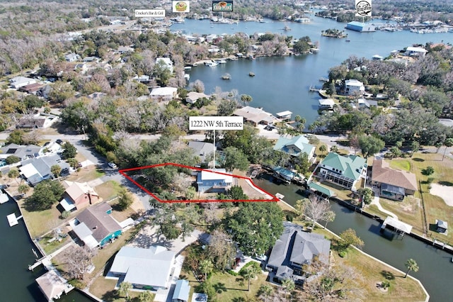 birds eye view of property with a water view and a residential view