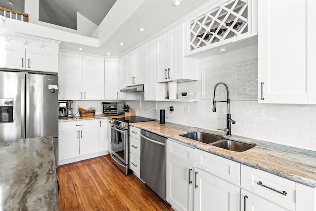 kitchen featuring stainless steel appliances, sink, and white cabinets