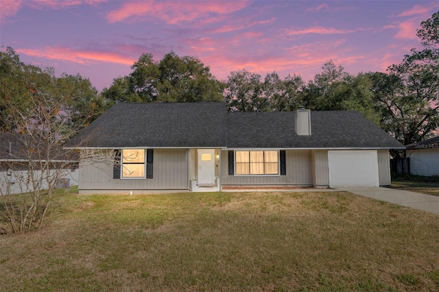 ranch-style house with a lawn and a garage