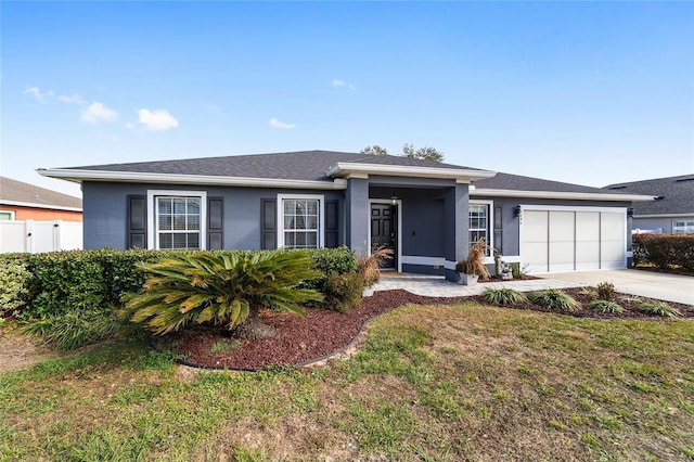 view of front of home featuring a garage and a front lawn