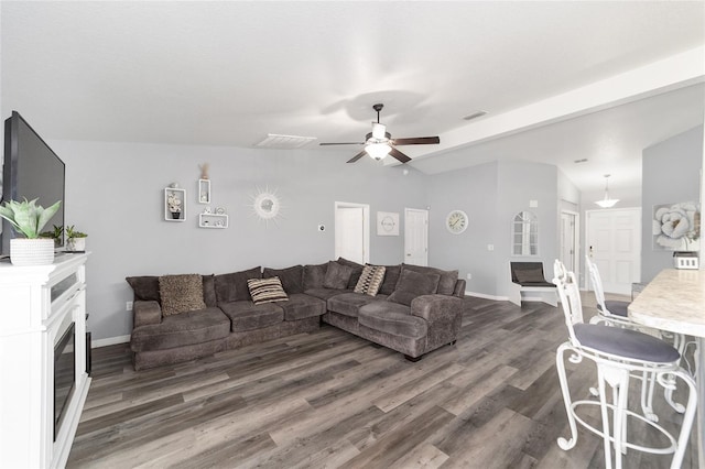 living room featuring ceiling fan, dark hardwood / wood-style flooring, and lofted ceiling