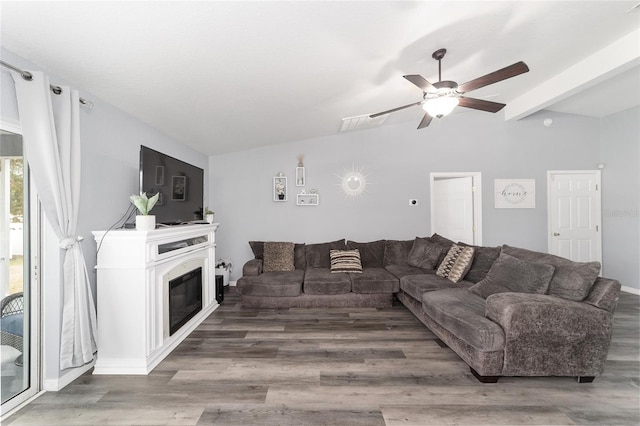 living room with hardwood / wood-style flooring, beam ceiling, and ceiling fan