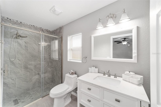 bathroom with toilet, a shower with shower door, and vanity