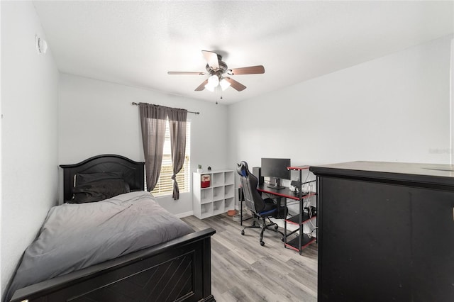 bedroom featuring light wood-type flooring and ceiling fan