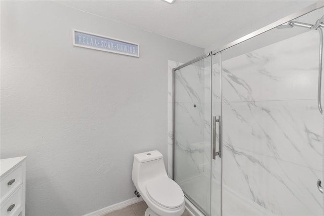 bathroom with toilet, an enclosed shower, and vanity