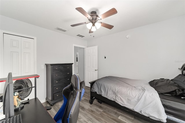 bedroom featuring ceiling fan, hardwood / wood-style flooring, and a closet