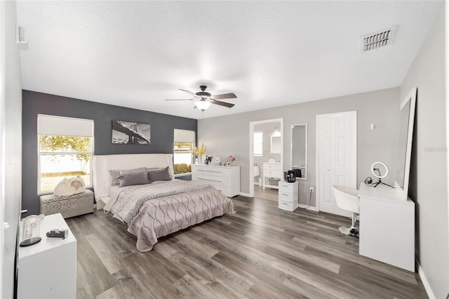 bedroom featuring ceiling fan, a textured ceiling, and wood-type flooring