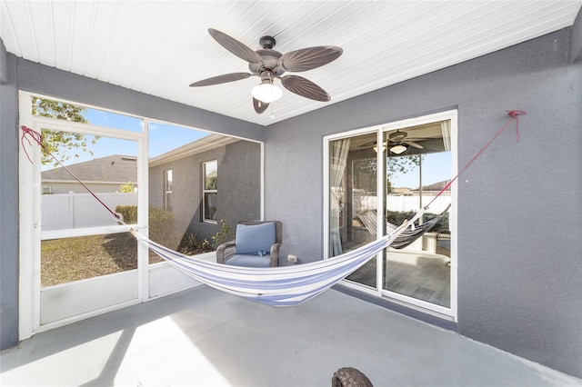 sunroom featuring ceiling fan