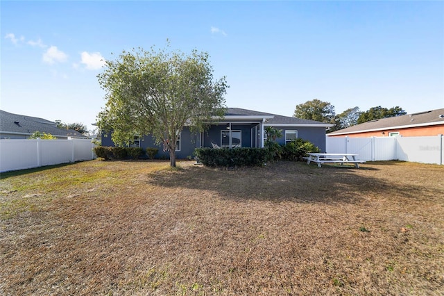 rear view of property featuring a yard